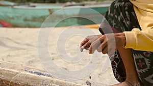 Close-up of hands untangling a fishing net. high quality