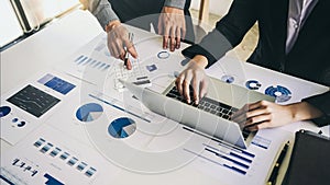 Close up hands using calculator of businessman and businesswoman discussing at meeting