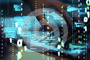 Close up of hands using computer keyboard with abstract coding binary code hologram on blurry background. Artificial intelligence