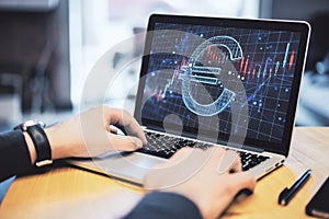 Close up of hands using laptop keyboard with creative glowing euro hologram and forex chart on screen, abstract wooden desk