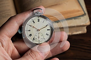 close up of hands with vintage pocket watch retro
