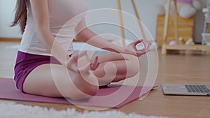 Close up hands of Wellness Athlete woman practice yoga lotus pose online course at home to meditation comfortable and relax,yoga