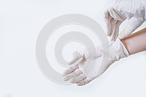 Close up of hands with white medical gloves for protection against coronavirus covid-19 infection. Cope space. Pandemic