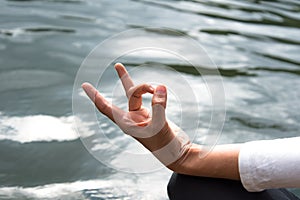 Close up hands. Woman do yoga outdoor. Woman exercising vital and meditation for fitness lifestyle club at the nature background.