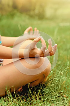 Close up hands. Woman do yoga outdoor. Woman exercising vital and meditation for fitness lifestyle club at the outdoors nature bac