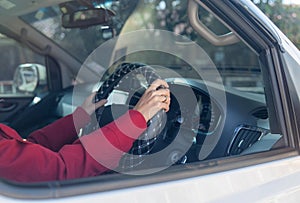 Close up hands of woman hold joystick or steering wheel of car with concept of safe drive and insurance of vehicle