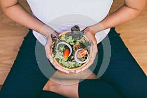 Close up hands woman holding breakfast salad for healthy,Top view