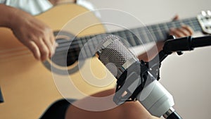 Close-up hands of woman playing acoustic classic guitar and record with microphone, Music instrumental for jazz and easy listening