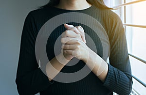 Close up of hand woman in praying position,Female pay respect or put your hands together in a prayer position photo