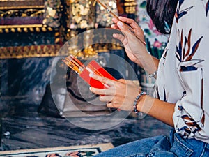 Close up hands woman is shake Chi-Chi Sticks or Seam-Si at Thai temple, one of stick is fortune and hope of her, Religion,