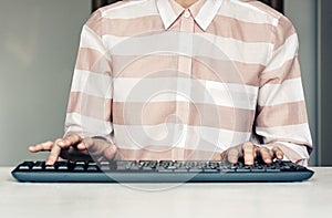 Close-up of hands woman typing on keyboard computer on white table, business concept