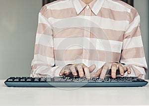 Close-up of hands woman typing on keyboard computer on white table, business concept