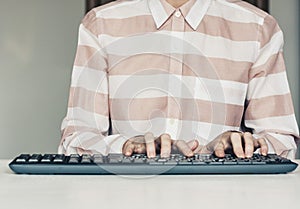 Close-up of hands woman typing on keyboard computer on white table, business concept