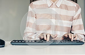 Close-up of hands woman typing on keyboard computer on white table, business concept