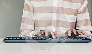 Close-up of hands woman typing on keyboard computer on white table, business concept