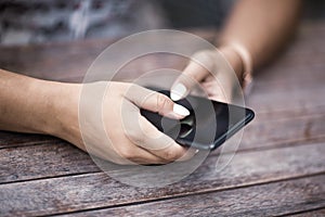 Close up of hands woman using her cell phone. Outdoor.