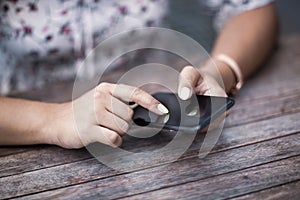 Close up of hands woman using her cell phone. Outdoor.