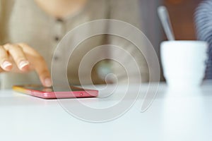 Close up of hands woman using her cell phone in restaurant,cafe