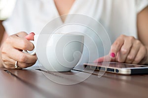 Close up of hands woman using her cell phone in restaurant