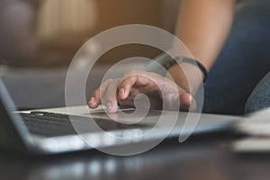 Close up hands of woman using laptop by touchpad