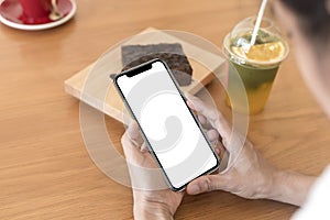 Close up hands of woman using mobile phone, cell phone in coffee shop. Hands of women holding blank empty screen smart phone in