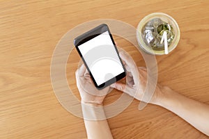 Close up hands of woman using mobile phone, cell phone in coffee shop. Hands of women holding blank empty screen smart phone in