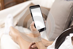 Close up hands of woman using mobile phone, cell phone in coffee shop. Hands of women holding blank empty screen smart phone in