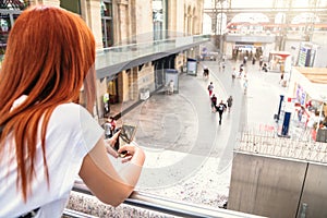 Close up hands woman using phone at train station