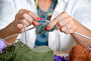 Close up of the hands of a woman who knits