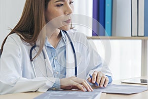 Close up hands of women doctor write prescription medical lab hospital. Crop asian women hand doctors working in medical clinic