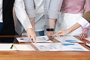 Close up hands of young business woman pointing to sale chart in paper report on table for brainstroming and disscussion in meetin