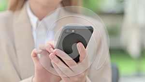 Close up of Hands of Young Businesswoman using Smartphone