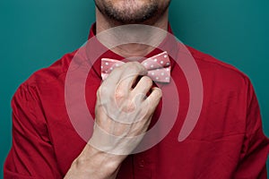 Close-up of the hands of a young man in red shirt