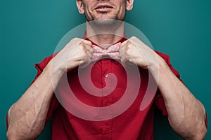 Close-up of the hands of a young man in red shirt