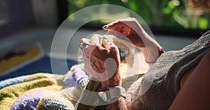 Close-up of the hands of a young woman holding knitting needles and knitting