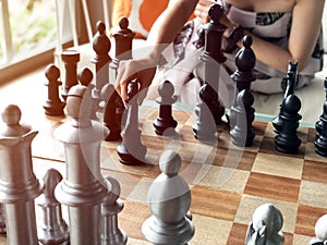 Close up of hands of young  woman playing chess