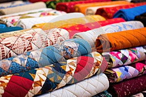 close-up of handsewn quilts in various patterns photo