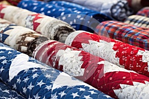 close-up of handsewn quilts in various patterns