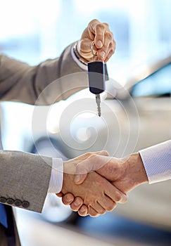 Close up of handshake in auto show or salon