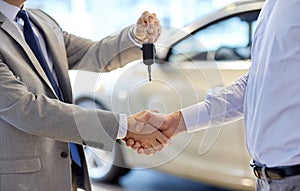 Close up of handshake in auto show or salon