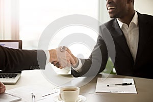 Close up of handshake between black and white business partners