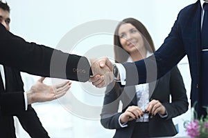 Close up.handshake of business partners in the background of the office