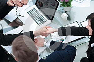 Close up.handshake business partners over the Desk