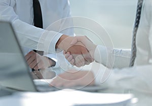 Close up.handshake business people at the Desk