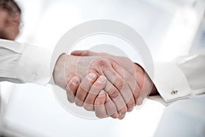 Close up.handshake of business people on a light background