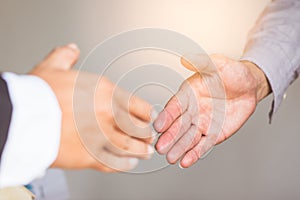Close up handshake of business people in meeting attendance.