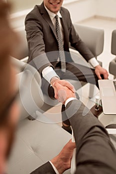 Close up.handshake business people in the office lobby