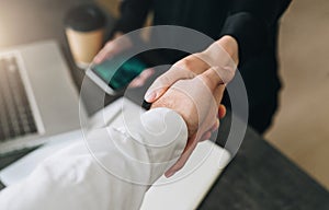 Close-up of handshake of businessman and businesswoman. Man`s hand shakes woman`s hand.Successful conclusion transaction