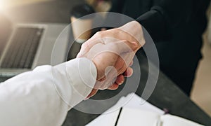 Close-up of handshake of businessman and businesswoman. Man`s hand shakes woman`s hand.Successful conclusion transaction