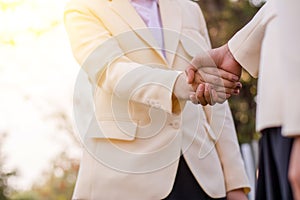 Close up of handshake on nature background. Teamwork concept.